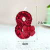 A red glitter number eight decorated with a satin bow, used for birthday and celebration cakes.