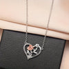 Silver heart-shaped pendant featuring a rose and leaves, displayed on a black gift box.
