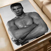Black and white photo of a muscular man posing, framed as a boxing poster.