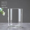A clear glass cylinder with a wide opening, used as a decor vase for plants.