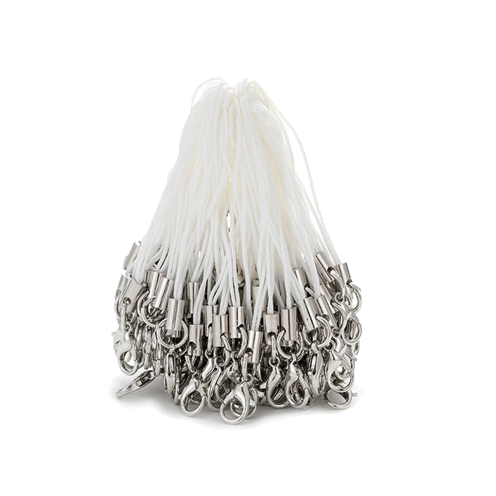 A bundle of white fishing line or thread with silver lobster clasps attached, used for jewelry making.