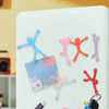 Colorful flexible mini figures attached to refrigerator magnets