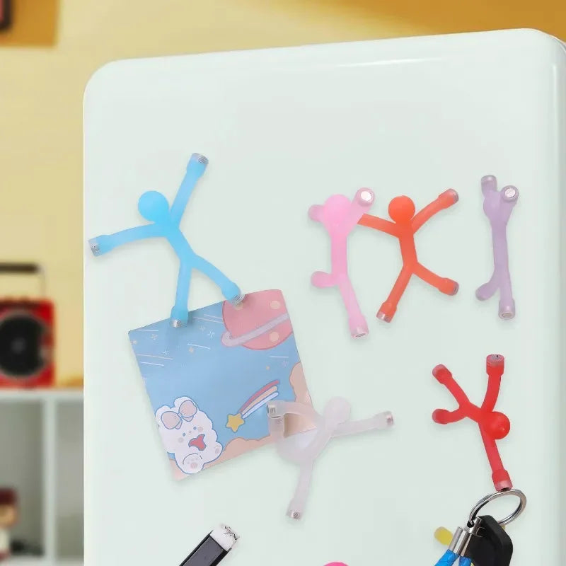 Colorful flexible mini figures attached to refrigerator magnets