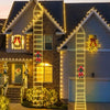 A house facade decorated with Christmas lights shaped like a Santa Claus climbing ladder on the front and garage.
