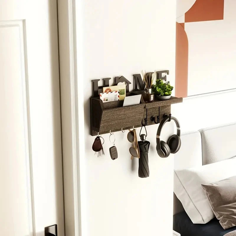 A rustic wooden wall key holder with a shelf and seven hooks mounted on a white wall above a bed.