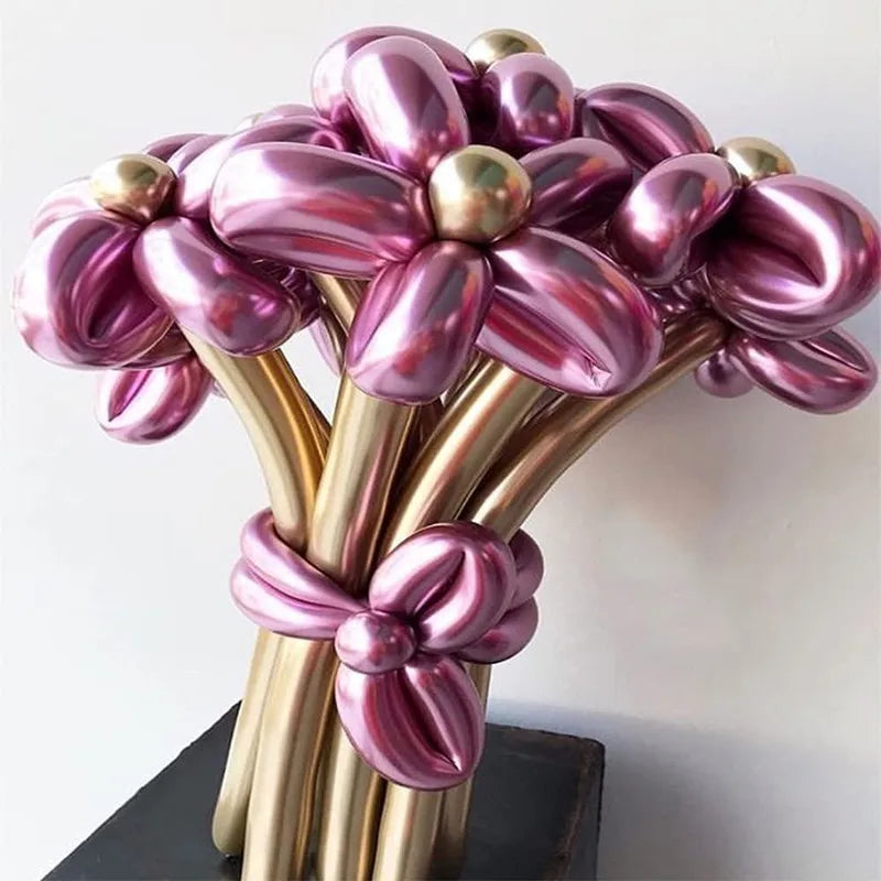 Glossy latex modeling balloons in shades of purple and gold arranged in a floral shape.