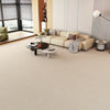 A light beige runner rug is displayed on a modern living room floor with a sectional sofa and large window.
