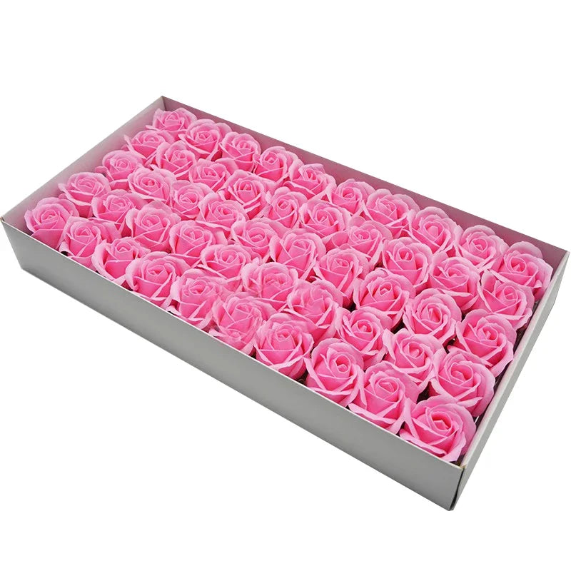 A rectangular box filled with pink artificial rose heads for wedding and party decor.