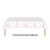 A rectangular pink disposable party table set featuring a repeating pattern of bows and birthday messages.