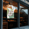 A custom self-adhesive poster print featuring a logo placeholder displayed in a bakery storefront window.
