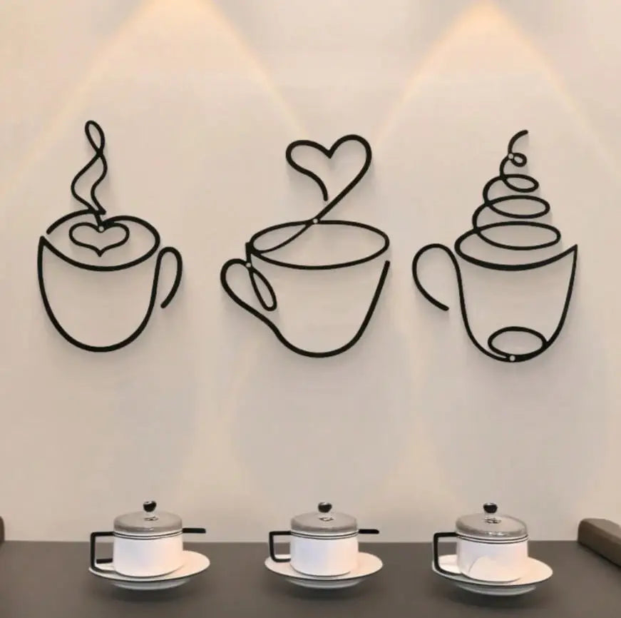 A trio of black metal wall art depicting steaming teacups against a white wall.