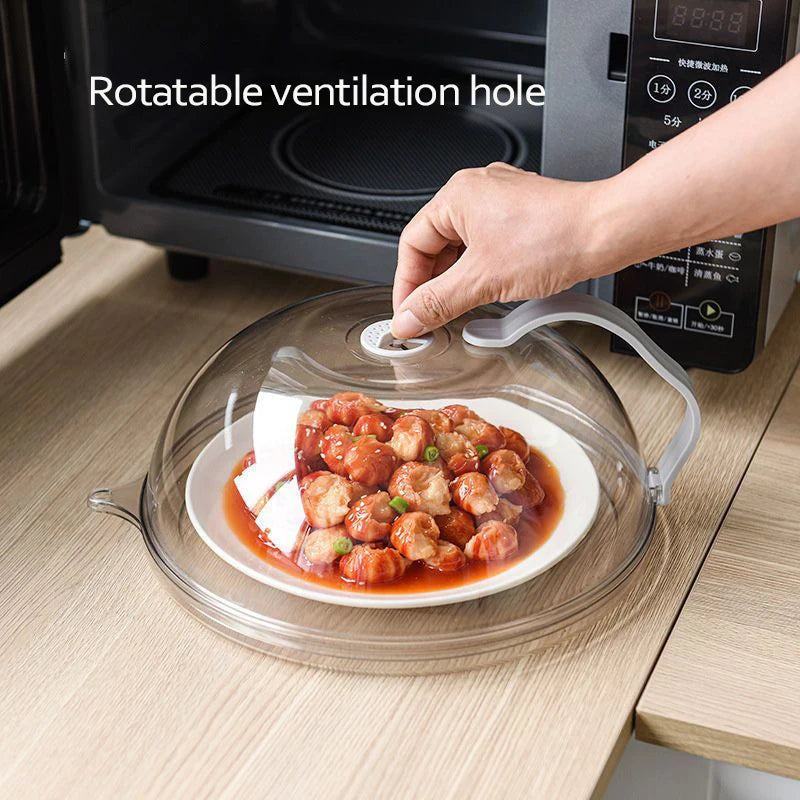A transparent microwave splatter guard with a handle is shown over a plate of cooked food.