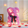 Pinker künstlicher Rosen-Teddybär mit leuchtenden Lichtern auf weißem Untergrund.