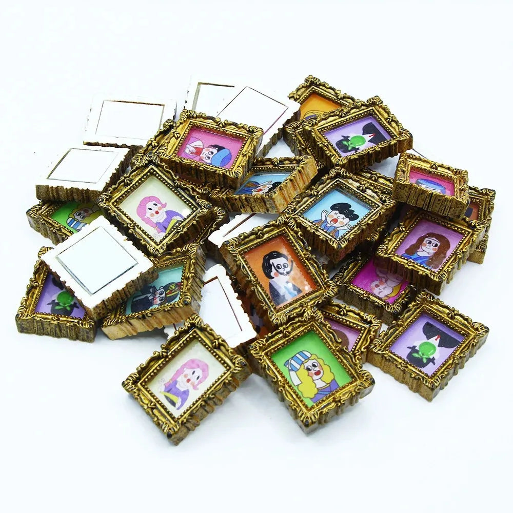 A pile of miniature framed wall art featuring colorful illustrations for dollhouse decor