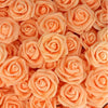 A close-up view of numerous artificial foam roses in various shades of peach and orange.