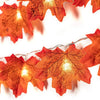 Orange decorative LED string lights garland featuring autumn leaf shapes.