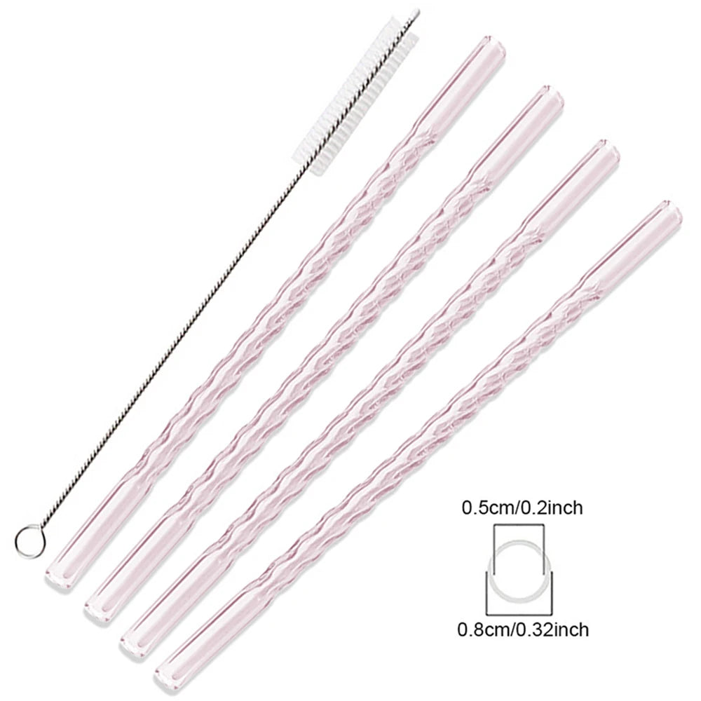 A set of clear pink borosilicate glass straws with cleaning brushes.