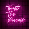 Pink neon sign spelling out Trust The Process on a dark purple grid background.