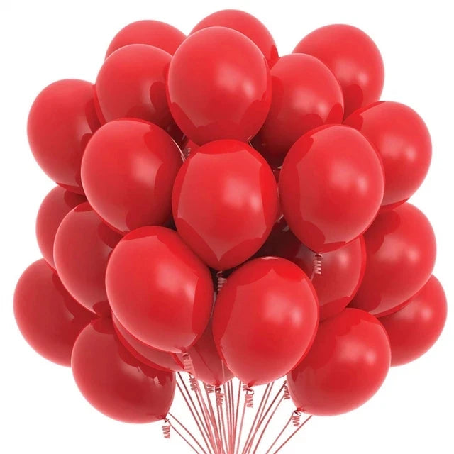 A bunch of red latex balloons with a cloud and cow print pattern for party decor