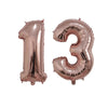 Two rose gold foil number balloons shaped like 1 and 3 displayed side by side