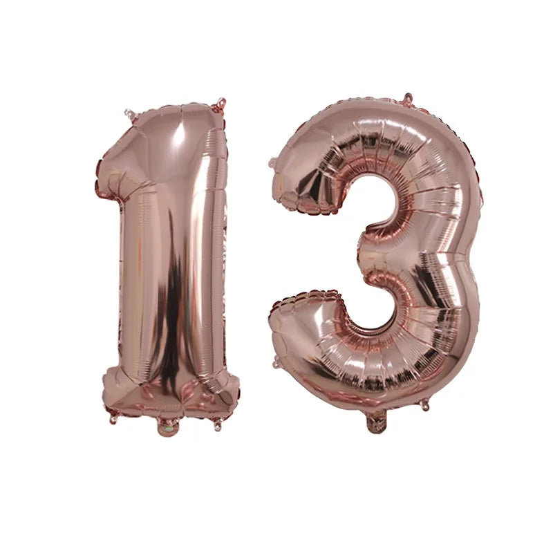 Two rose gold foil number balloons shaped like 1 and 3 displayed side by side