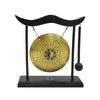 A black desktop zen gong mounted on a stand with a wooden mallet.