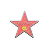 A red star enamel pin with the words JESUS CHRIST and a cross in the center.