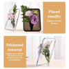 Clear acrylic frame flower vase with purple and pink flowers displayed on a white surface.