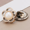 A pair of gold-toned and silver-toned pearl and rhinestone no-sew brooch buttons.