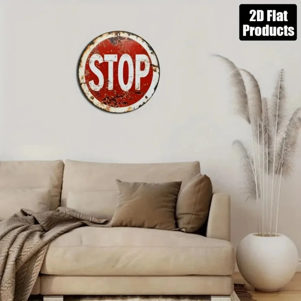 Vintage metal round stop sign wall decor mounted on a white wall above a beige sofa.