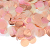 Pink and peach round tissue paper confetti dots scattered on a white background