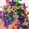 A hand holds a colorful collection of 3D printed articulated gecko desk toys.