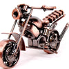 A handcrafted metal motorcycle model with copper and bronze finishes displayed against a white background.
