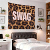 A large tapestry featuring a brown and black leopard print design hanging above a modern bed.