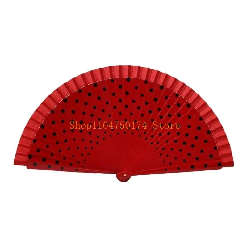 Red wooden hand fan with a pleated design and small black dots