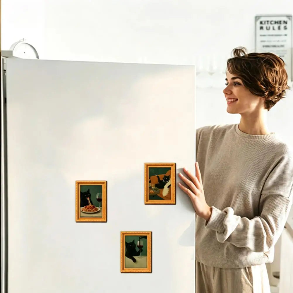 A woman in a beige sweater displays vintage style wooden fridge magnets featuring playful black cat art.