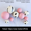 Ten cake toppers featuring cow and pink designs in various sizes