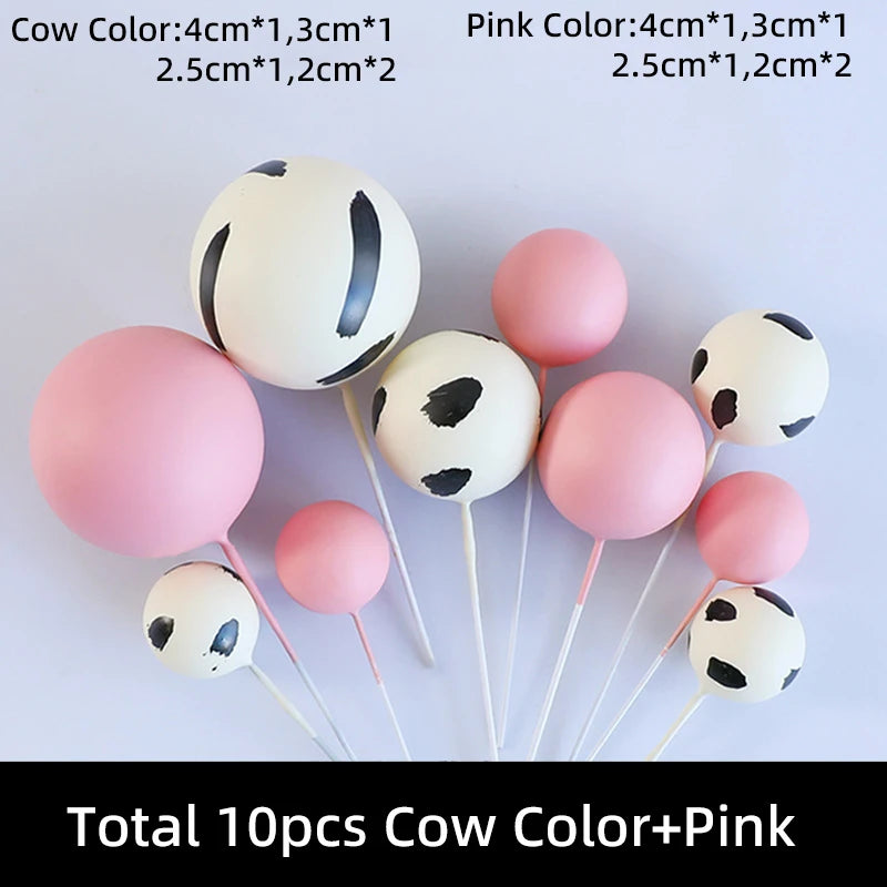 Ten cake toppers featuring cow and pink designs in various sizes