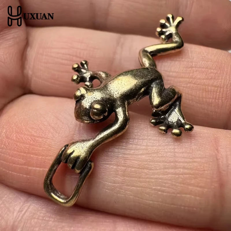 Vintage brass frog statue desktop ornament resting on a person's hand