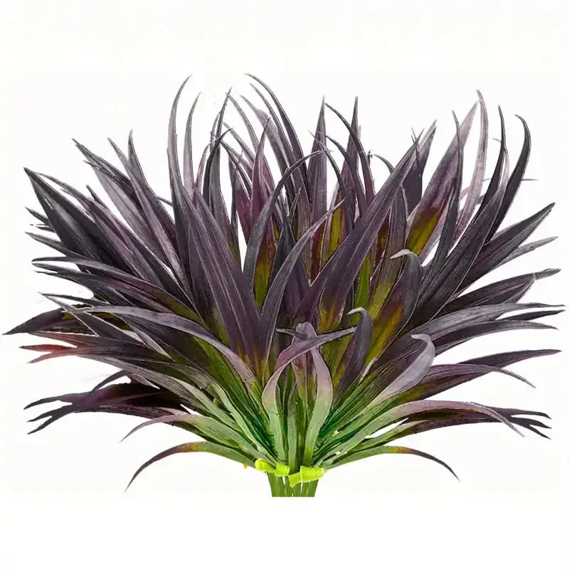 A close-up of a dark purple and green artificial tall grass and tropical flower arrangement.