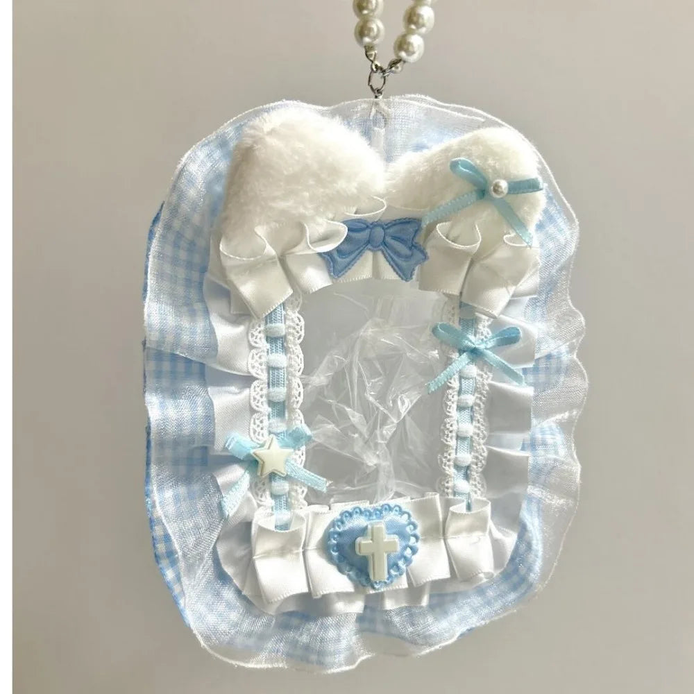 Porte-cartes fait main avec tissu à carreaux bleu clair, ruban blanc et nœuds bleus avec un charm argenté.