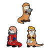 A set of enamel pins featuring cartoon characters, including a monkey with a gun and a cat wearing a uniform.