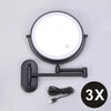 A round, illuminated magnifying makeup mirror with a black mounting bracket and USB charging cable.