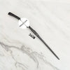 A black metal magic wand replica with a 36cm length is displayed on a white marble surface.