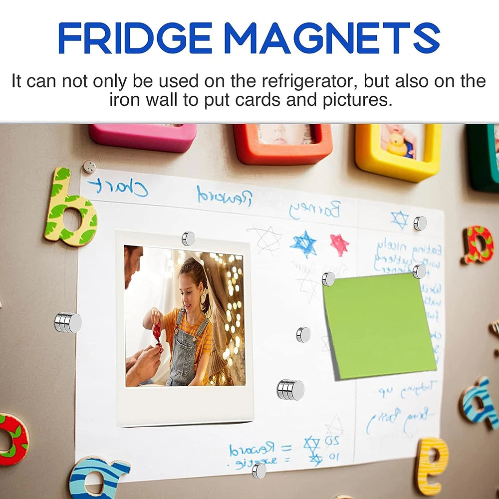 A white magnetic board displaying photos and notes, surrounded by various colorful magnets.