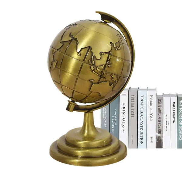 A vintage bronze globe with an antique world map, used as desk decor.