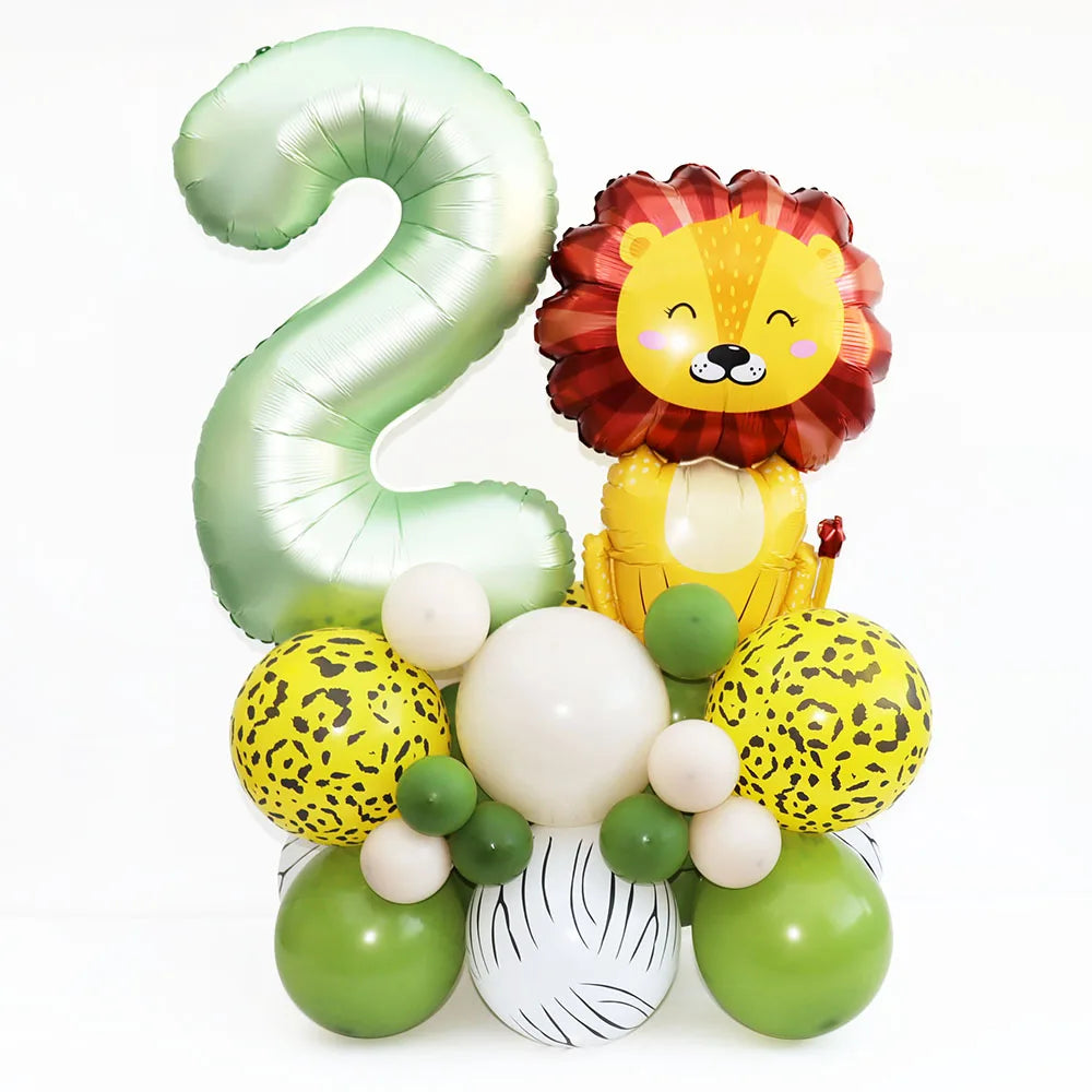 Green foil balloon shaped like the number 2 next to a yellow lion balloon and various spherical balloons