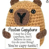 Handmade crochet baseball bat doll with a positivity card featuring a capybara face.