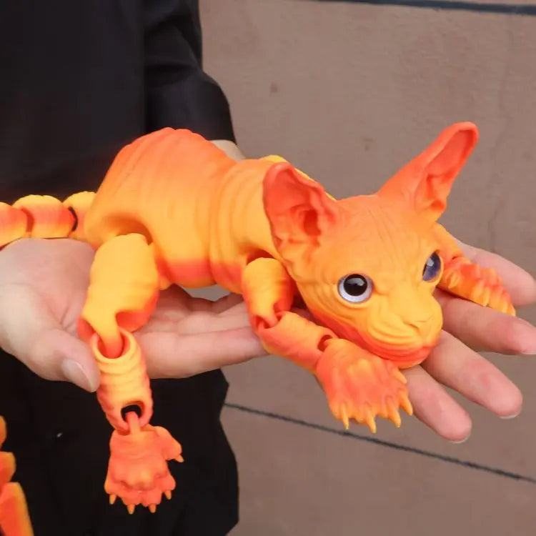 A hand holds an orange realistic Sphynx cat fidget toy with detailed texture and large eyes.