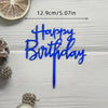 Blue acrylic birthday cake topper with happy birthday lettering and a gold slice of citrus fruit